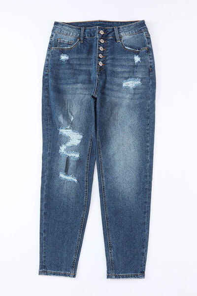 Jeans desgastados con bragueta de botones y bolsillos